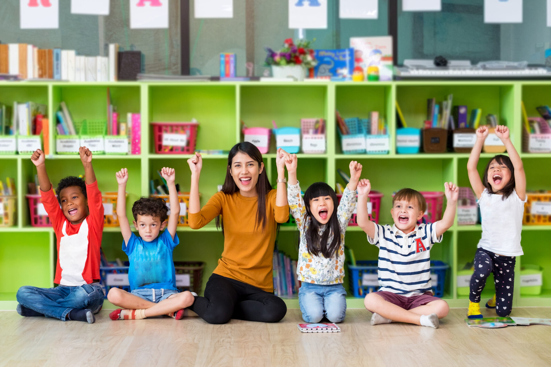 Happy Asian female teacher and mixed race kids in classroom,Kind Happy Asian female teacher and mixed race kids in classroom,Kindergarten pre school concept