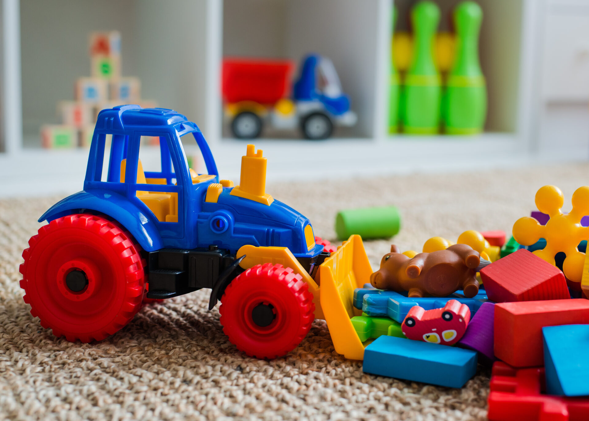 Children's playroom with plastic colorful educational blocks toys. Children's playroom with plastic colorful educational blocks toys. Games floor for preschoolers kindergarten. interior children's room. Free space. background mock up